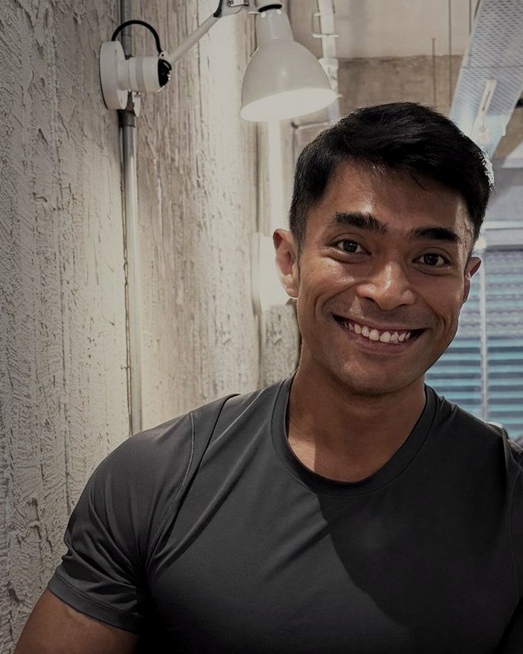 Riz smiling at a cafe table